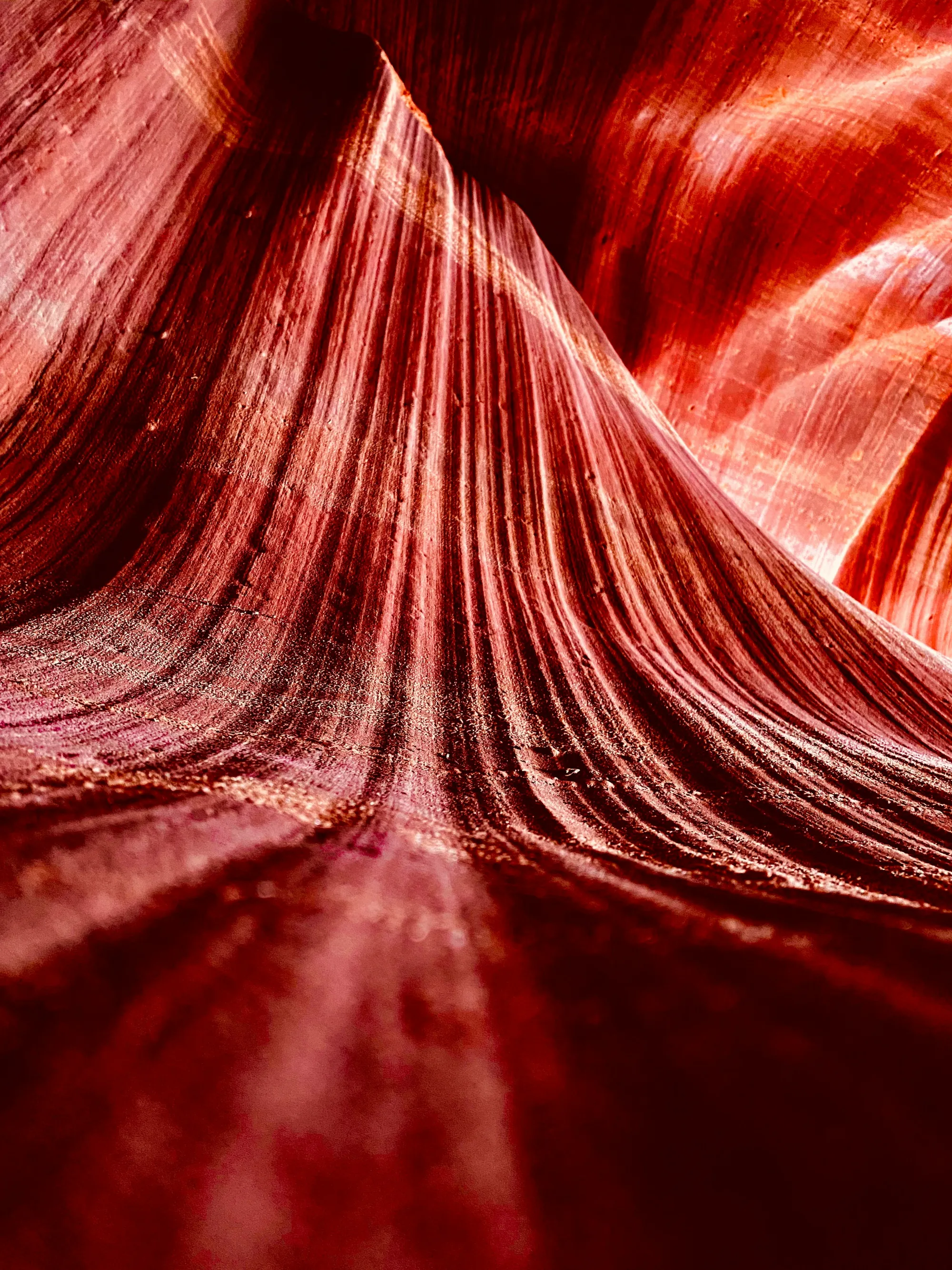Flowing red sandstone curves inside a slot canyon