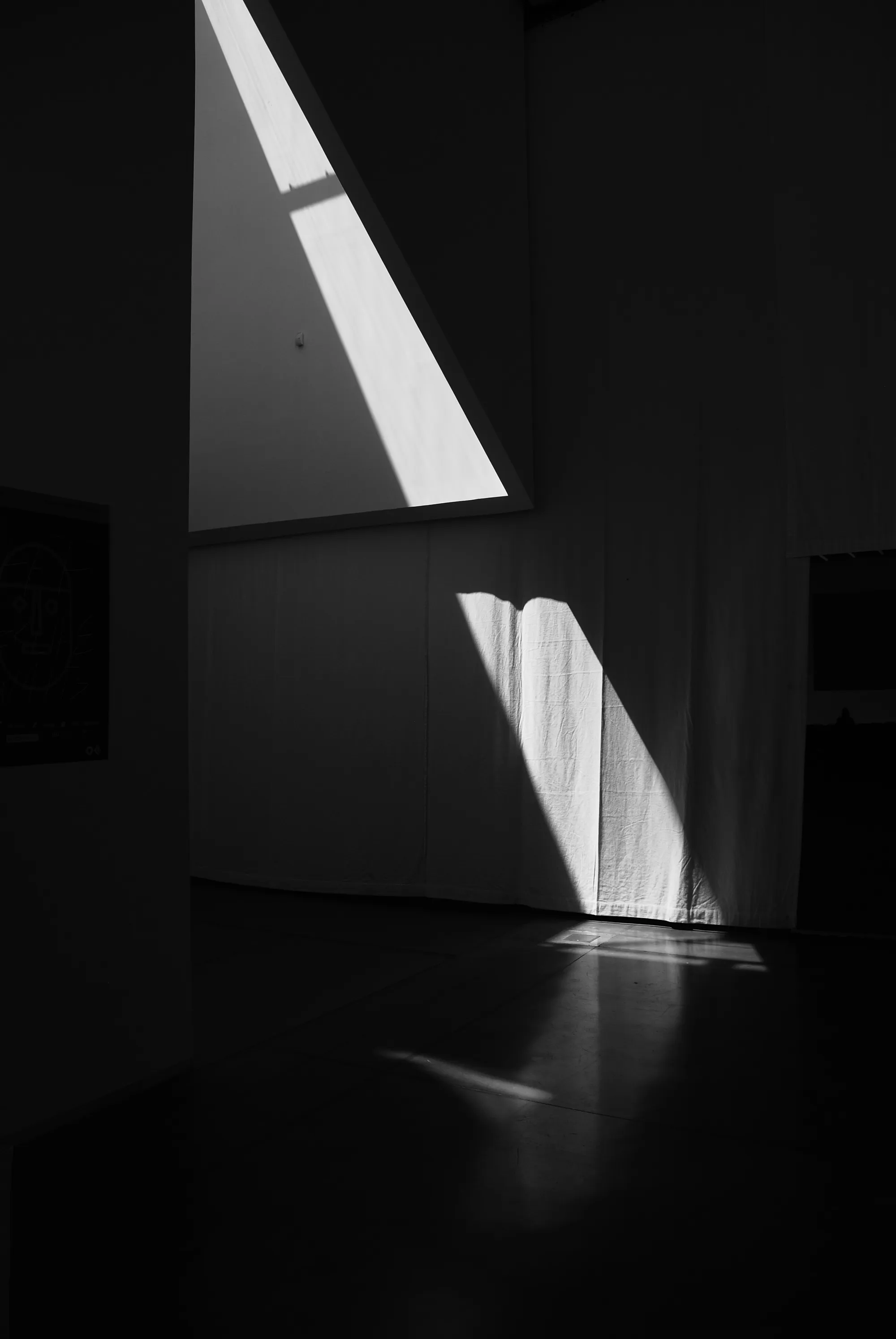 A sliver of light cutting through a dark room